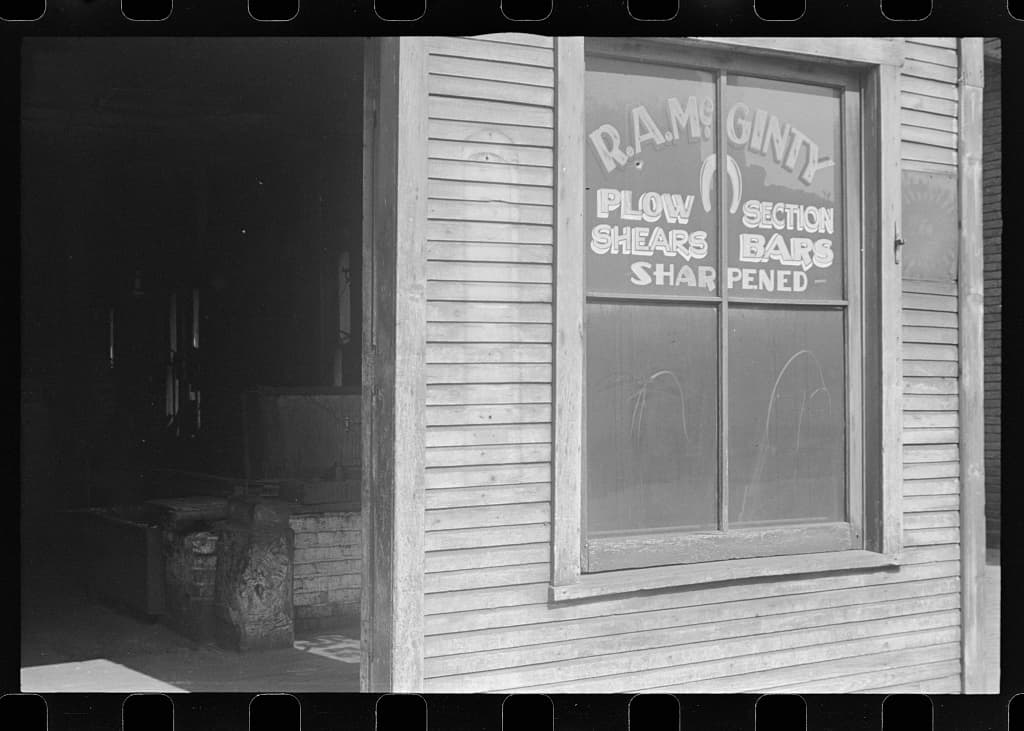 A village blacksmith shop with a hand-painted trade sign, Ohio, 1938