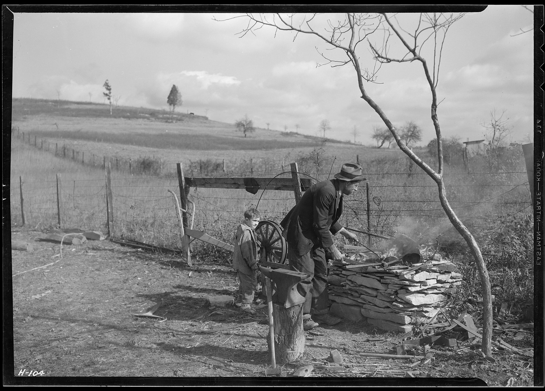 A blacksmith works at his outdoor forge in rural Tennessee, 1933